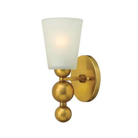 The Zelda 1 Light Wall Light - Vintage Brass captivates with its wall-mounted design, showcasing a vintage brass finish and three spherical elements. Its etched glass shade emits a soft glow, merging modern geometric shapes with a warm metallic hue.