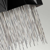 Close-up of a black geometric umbrella with shiny metallic fringes hanging down. The fringes resemble chains, creating a striking contrast against the smooth black surface, much like how contemporary design enhances ambient lighting in spaces featuring the Zuma 3 Light Wall Light - Satin Black/Silver.