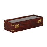 Rectangular wooden watch and jewellery box in brown with reddish grain, gold-coloured corner fittings and front clasps, clear window lid, shown closed on a white background.
