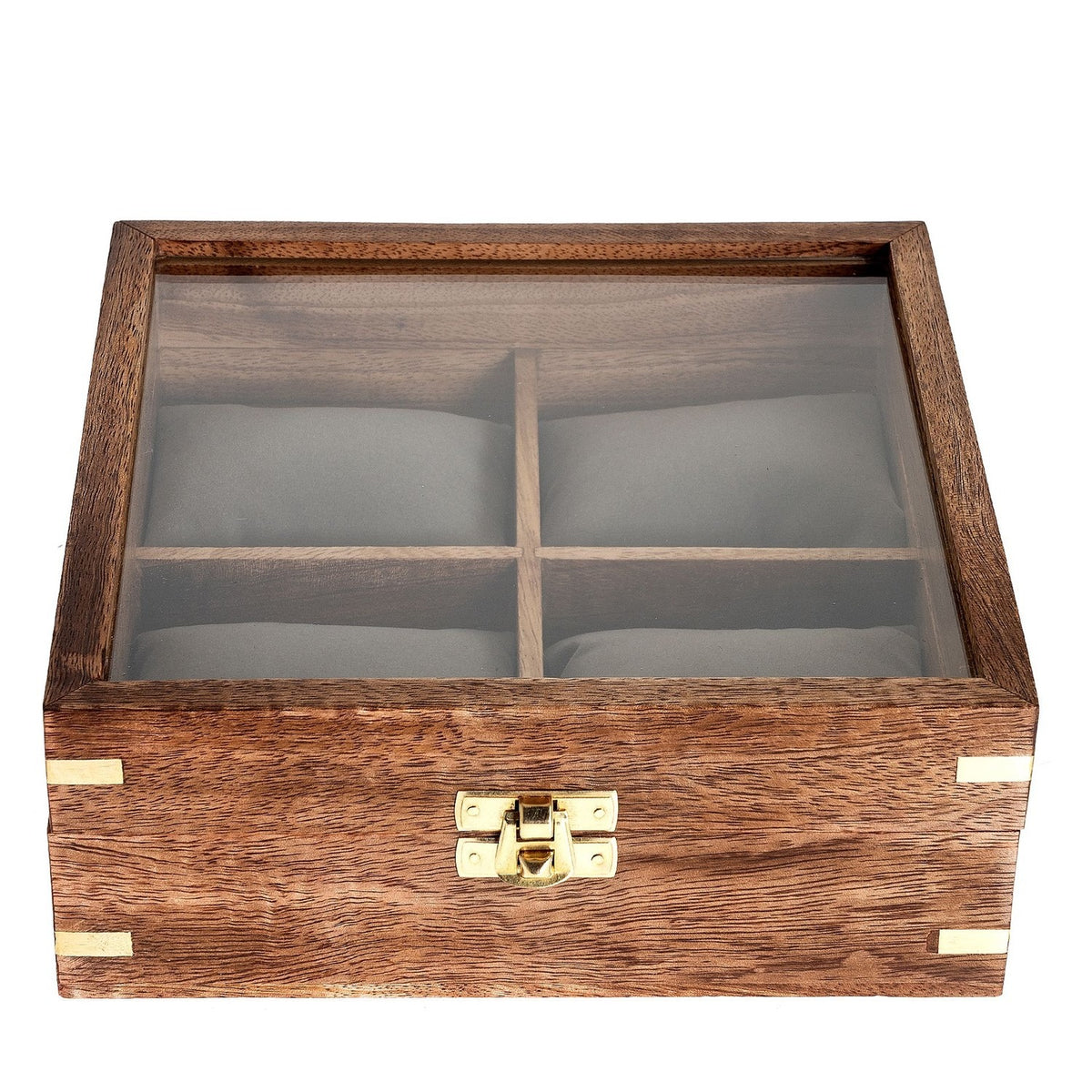 Square wooden watch box with glass lid revealing four grey cushioned compartments, brown wood finish with gold-coloured corner accents and front clasp, on a white background.