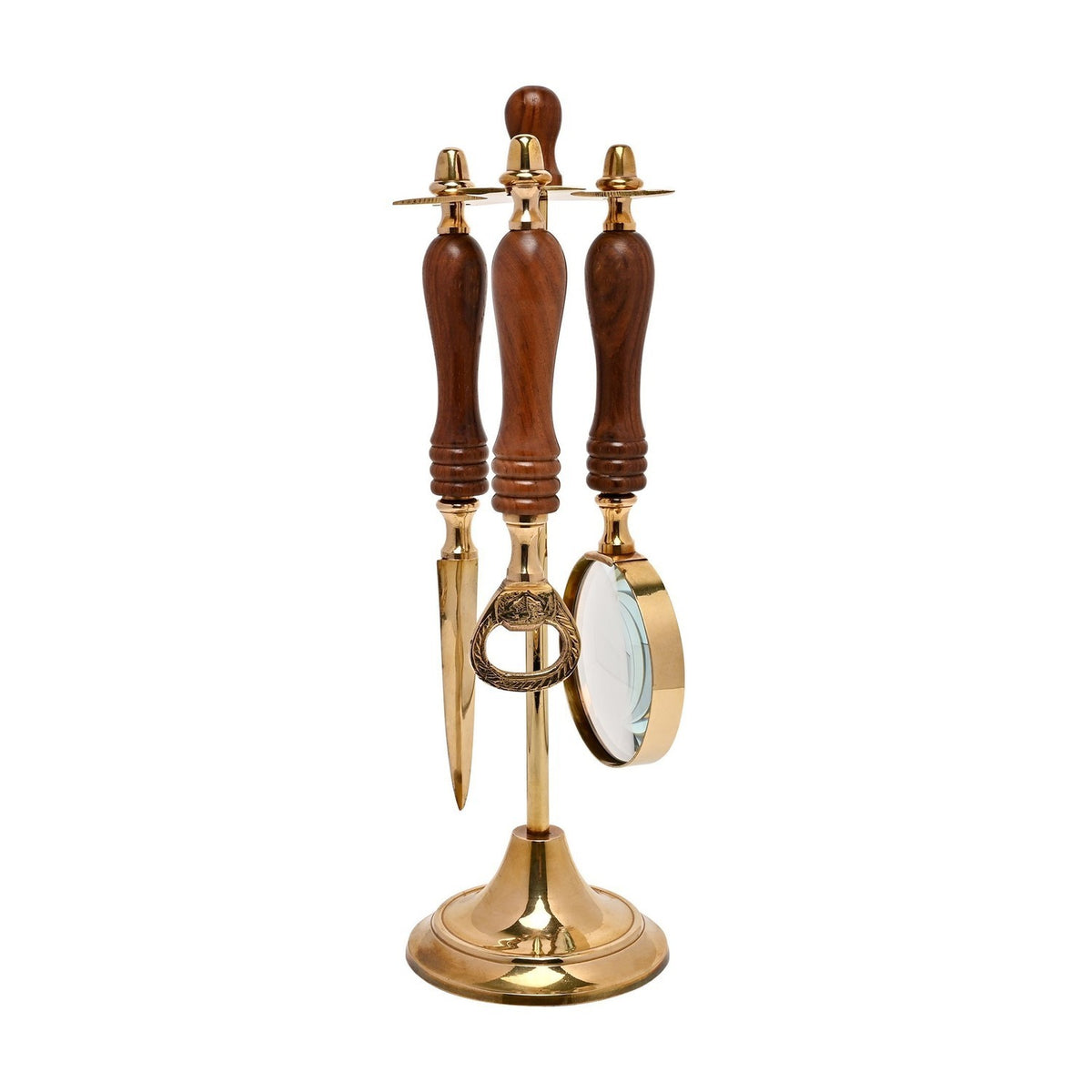 Letter opener, bottle opener, and magnifying glass with brown turned wood handles hang from a gold crossbar on a brass stand, set against a plain white background.