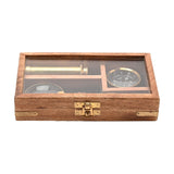 Magnifying Glass Set with Telescope and Compass in a brown wood hinged case with glass lid and gold-coloured clasp, hinges and corner fittings, shown closed on a white background.