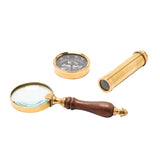 Magnifying glass set with brass round magnifier, wood handle, compass dial and extendable telescope, shown unboxed on a plain white background.