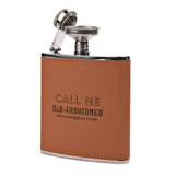 Brown leather-wrapped 6oz hip flask with "Call Me Old-Fashioned" lettering, orange stitching, stainless steel cap and funnel, on a white background.