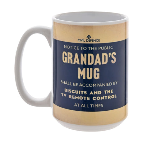 White stoneware mug with navy and tan Civil Defence style notice reading "Grandad's Mug shall be accompanied by biscuits and the TV remote control," on a plain white background.