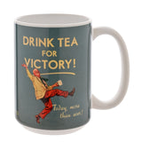 White glazed stoneware mug with white handle, printed with "Drink Tea For Victory!" slogan and a dancing man in a yellow jacket and red trousers, on a plain background.