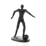 Black resin footballer figurine on an oval base, textured finish, faceless head, arms outstretched, one foot resting on a ball, shown against a plain white background.