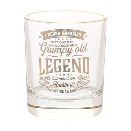 Clear glass tumbler with a gold rim, printed with "Grumpy Old Legend" slogan text and flourishes in gold, shown on a plain white background.