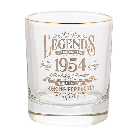 Clear glass tumbler with gold rim, featuring gold text "Legends Were Born in 1954, Absolutely Awesome, Built to Last, Ageing Perfectly" on a plain white background.