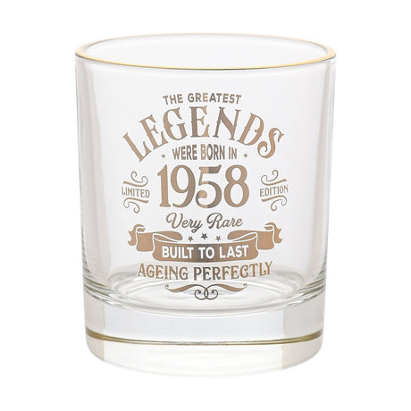 Clear glass tumbler with gold rim and gold text reading The Greatest Legends Were Born in 1958, Very Rare, Built to Last, Ageing Perfectly, with star and scroll details, on a white background.
