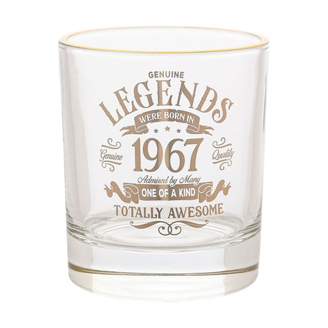 Clear glass tumbler with gold rim and gold "Legends Were Born in 1967" text design, photographed on a plain white background.