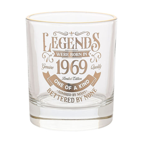 Clear glass tumbler with a gold rim, printed with "Legends Were Born in 1969" gold lettering and flourishes, shown on a plain white background.