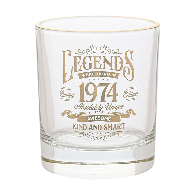 Clear glass tumbler with gold rim, printed in gold with "Legends were born in 1974" vintage lettering and scrollwork, on a plain white background.