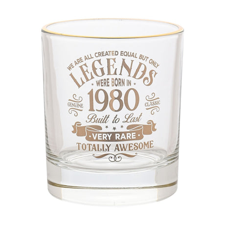 Clear glass tumbler with gold rim, printed with "Legends Were Born in 1980" vintage-style text in gold, shown on a plain white background.