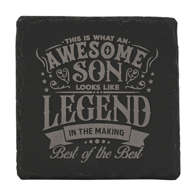 Square black slate coaster with engraved grey text reading "This is what an awesome son looks like, Legend in the making, Best of the Best," framed by stars and scrollwork.