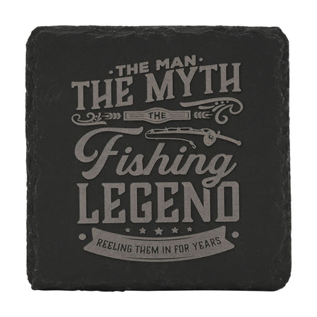 Square black slate coaster engraved with "The Man, The Myth, The Fishing Legend" text, a fishing rod design, stars, and a banner reading "Reeling Them In For Years," on a white background.