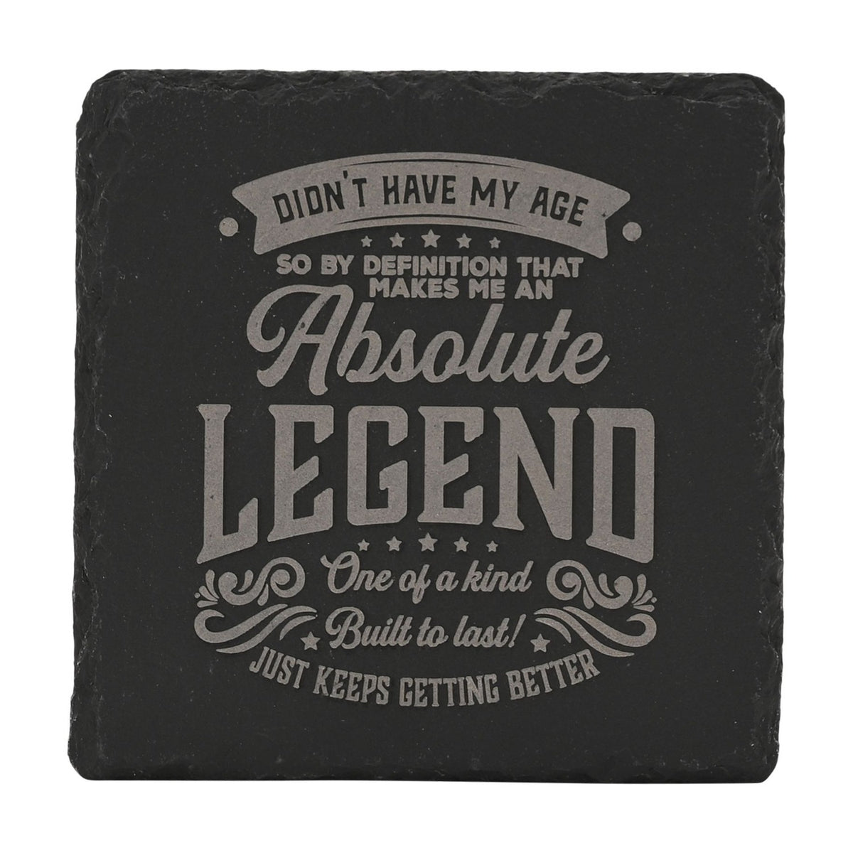 Square black slate coaster with grey engraved text reading "Didn't Have My Age Absolute Legend," framed by stars and flourishes, on a white background.