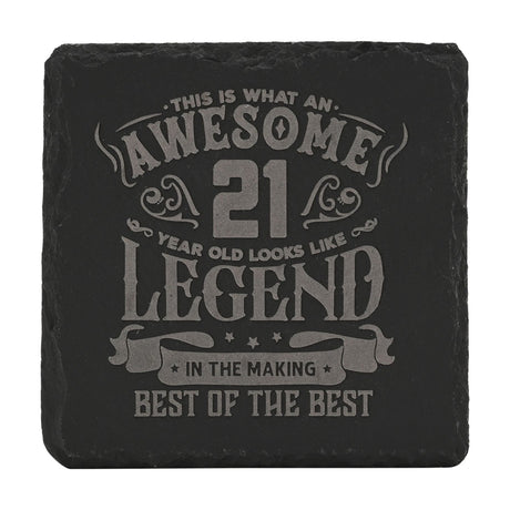 Square black slate drinks coaster with rough-edged border, engraved in grey text "Awesome 21 Year Old Looks Like Legend, In The Making, Best Of The Best" on a plain white background.