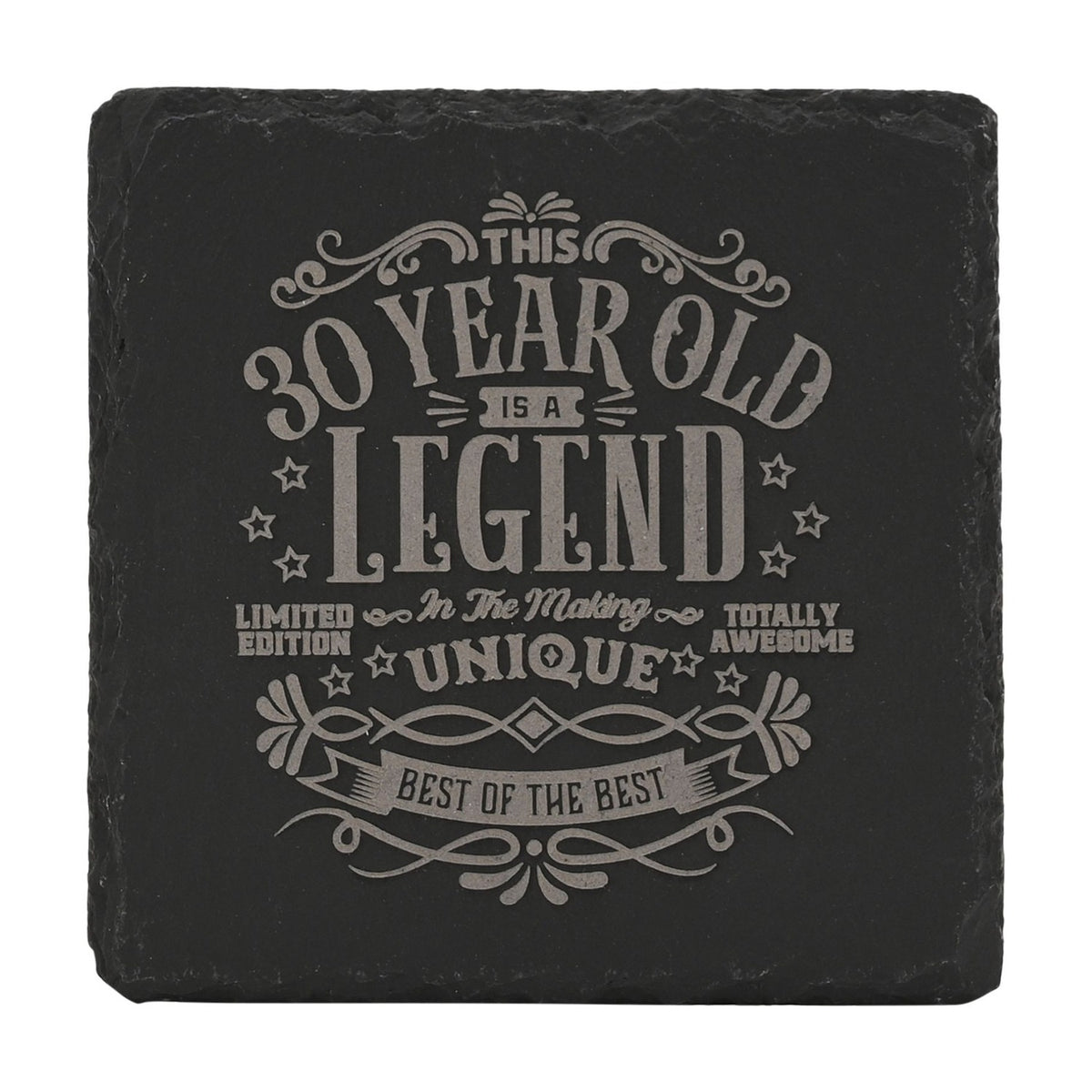 Square black slate coaster with raw edges, engraved in grey with This 30 Year Old Is a Legend In The Making text surrounded by stars and scroll flourishes, on a white background.