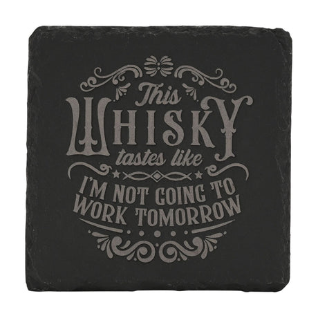 Square black slate coaster engraved with grey lettering reading "This WHISKY tastes like I'M NOT GOING TO WORK TOMORROW", framed by scrolled flourishes and stars, shown on a plain white background.