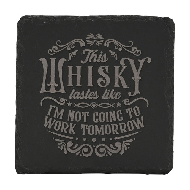 Square black slate coaster engraved with grey lettering reading "This WHISKY tastes like I'M NOT GOING TO WORK TOMORROW", framed by scrolled flourishes and stars, shown on a plain white background.