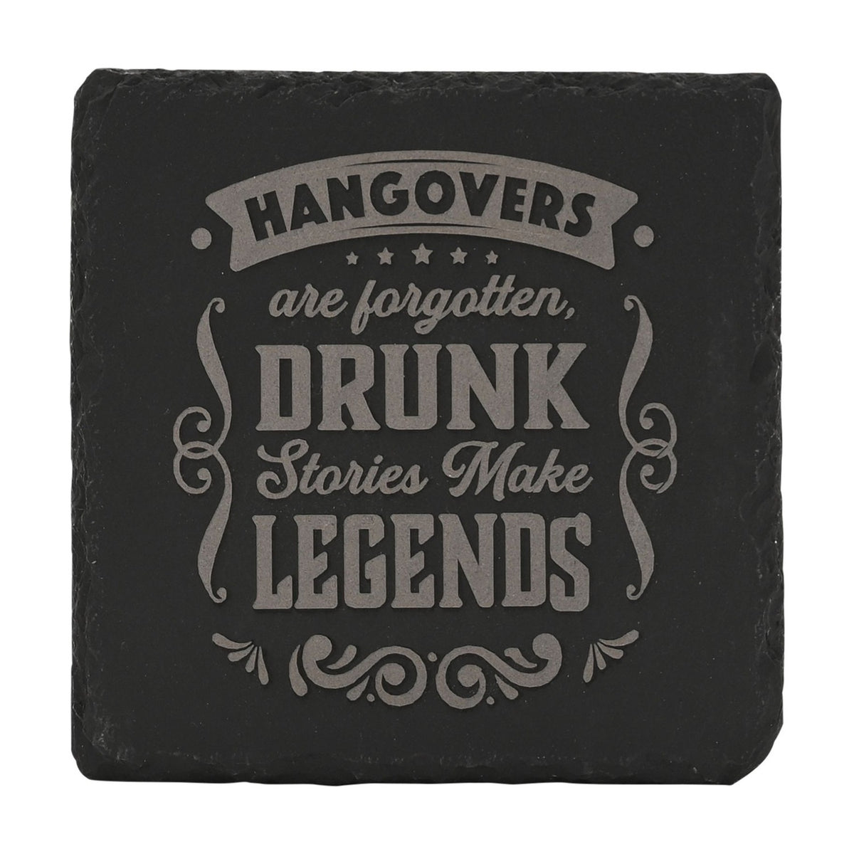 Square black slate coaster with raw edges, engraved in grey with "Hangovers are forgotten, drunk stories make legends" within a banner, stars, and scrollwork design, on a plain white background.
