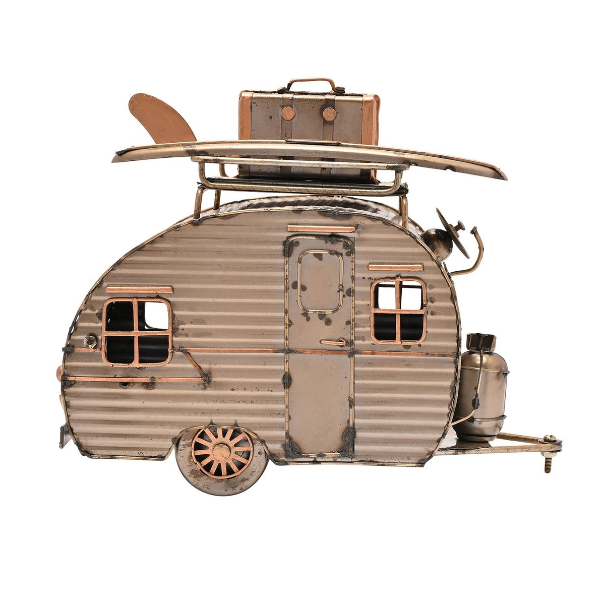 Teardrop Caravan Ornament metal figurine in gold with aged edges, corrugated panels, framed windows, and a roof rack holding a surfboard and suitcase, shown on a plain white background.