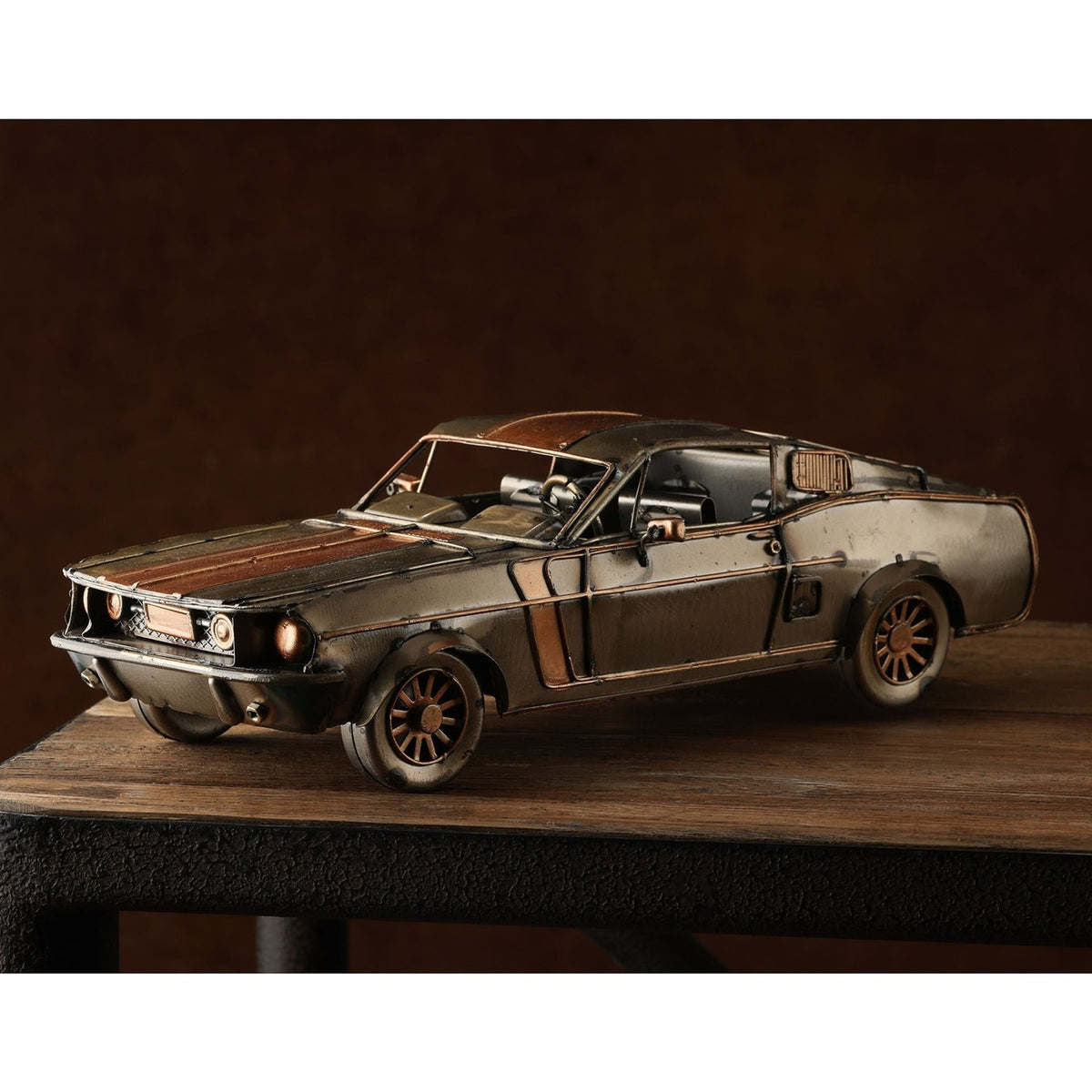 Striped Fastback Racing Car metal ornament figurine in bronze with copper-toned stripes, distressed weathered finish, spoked wheels and round headlamps, displayed on a wooden surface.
