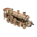 Steam train metal ornament figurine in antique bronze with copper-toned trim, featuring a riveted boiler, twin stacks, cab with roof, and spoked wheels, shown on a plain white background.
