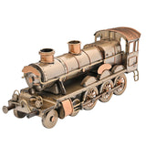 Steam Train Metal Ornament Figurine with Copper Trim in antique bronze, showing riveted boiler, twin copper-toned stacks, spoked wheels and cab with curved roof on a plain white background.