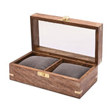 Wooden watch duo trinket box in brown with a glass window lid open, showing two grey cushioned compartments, brass corner accents and front clasp, on a white background.