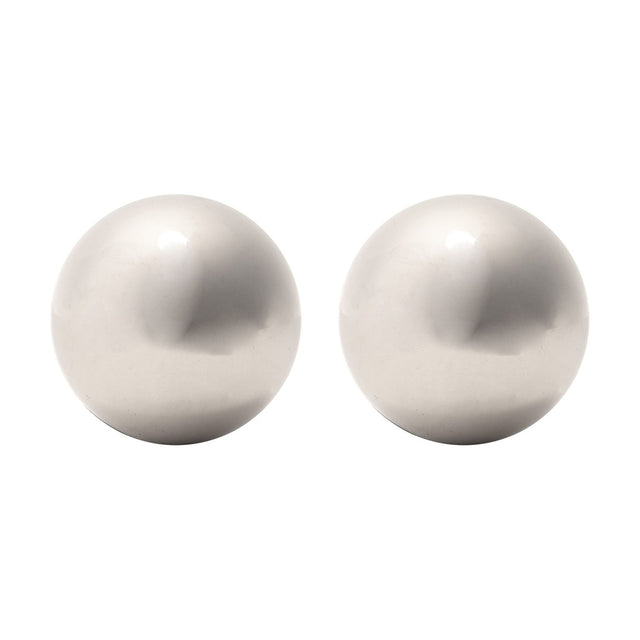 Two large round metal whisky stones in polished silver, smooth spherical chilling balls shown on a plain white background.