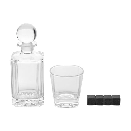 Clear glass whisky decanter with squared bevelled body, ball stopper and starburst base, matching square tumbler and four dark cooling cubes on a white background.