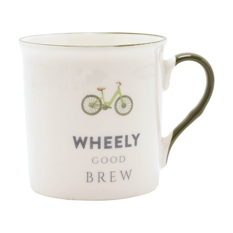 White porcelain mug with a green bicycle illustration, "WHEELY GOOD BREW" text in grey, a fine green rim line, and a green glazed handle, shown on a plain white background.