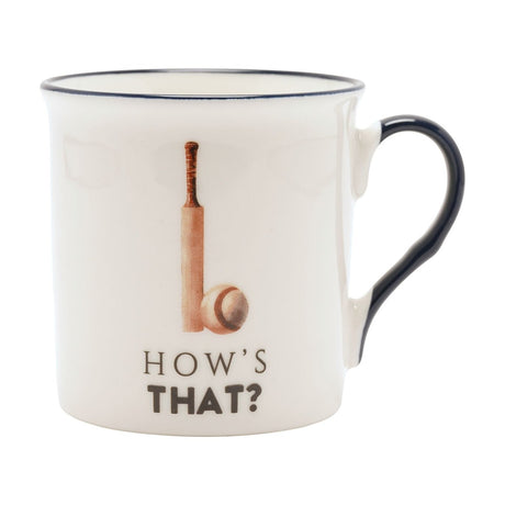 Cream porcelain mug with navy rim and handle, featuring a painted cricket bat and ball above "HOW'S THAT?" text, shown on a plain white background.