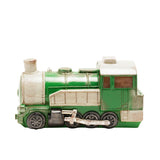 Steam train table lamp in green with cream panelled boiler, cab and chimney, black wheels, silver coupling rods and rivet detailing, shown on a plain white background.
