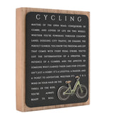 Cycling Wooden Plaque with Green Bicycle in Black & Natural, featuring white cycling-themed text on a black panel set within a natural wood frame, shown on a plain white background.