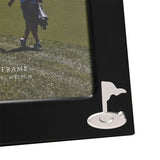 Close-up of the Golf Flag Matt Metal Photo Frame's corner, showing a matt black finish and a small silver golf flag with ball emblem beside a 6 x 4in photo.