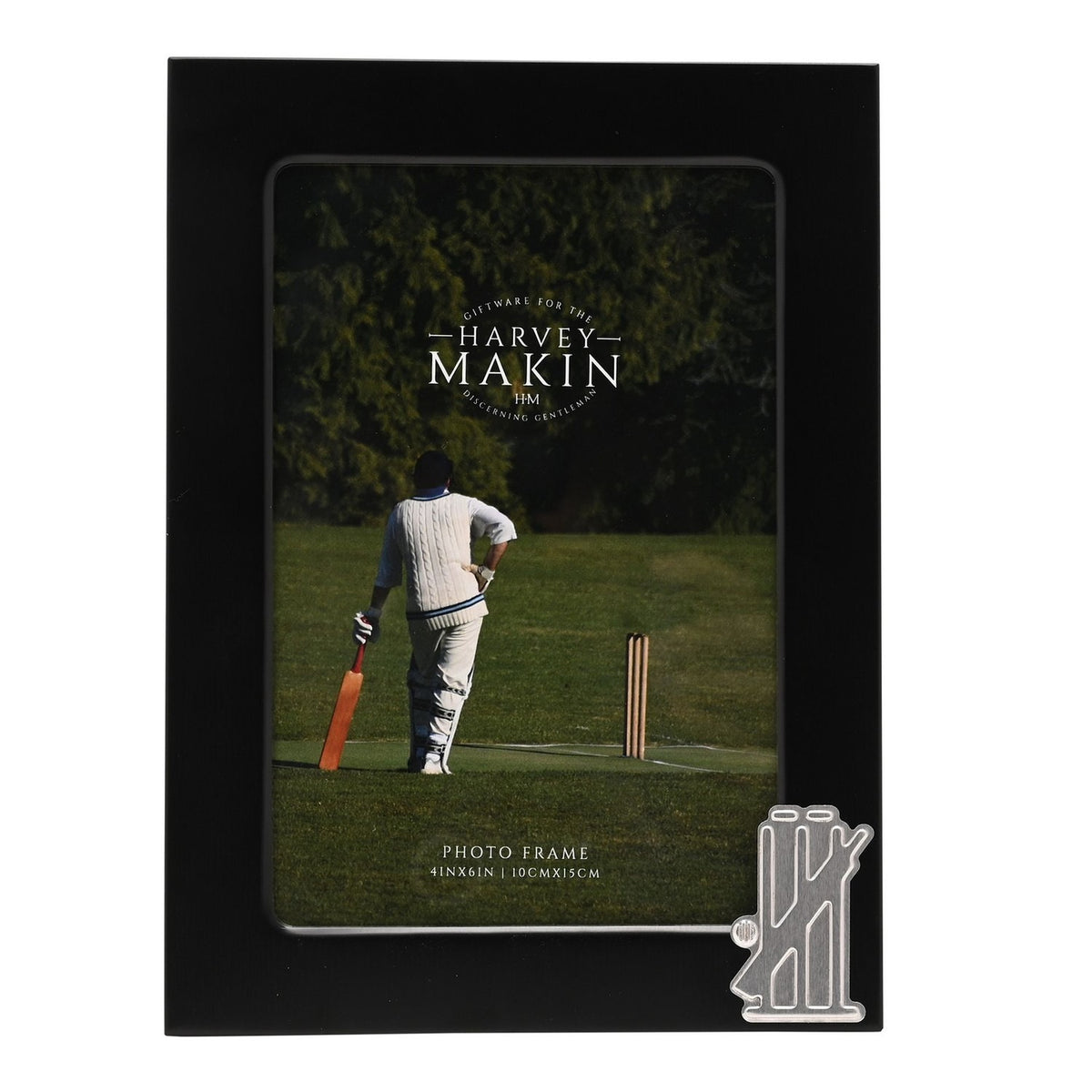 Black metal rectangular photo frame for a 6 x 4in picture, with a silver cricket stumps, bails and bat emblem on the lower right corner.