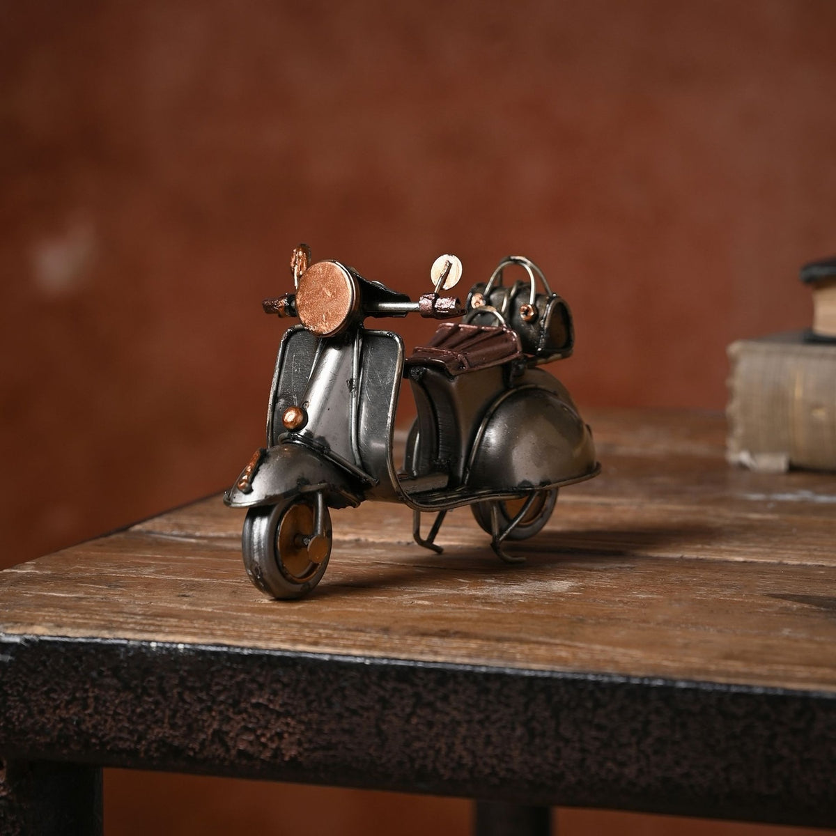 Retro Scooter Metal Ornament Figurine in bronze and copper, featuring curved bodywork, round headlamp, twin mirrors and copper seat, displayed on a wooden table.