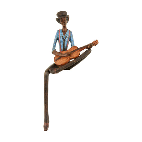 Hill Interiors Sitting Musician Figurine in resin, seated player in blue top and brown hat with acacia guitar and elongated legs, on a white background.