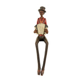 Hill Interiors Sitting Musician with Squeeze Box Figurine in brown resin, seated with long dangling legs, red top, hat and accordion, on a white background.