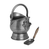 Hill Interiors Antique Pewter Coal Bucket with rounded hammered body, swing handle, decorative side mounts and matching wooden-handled shovel on white.