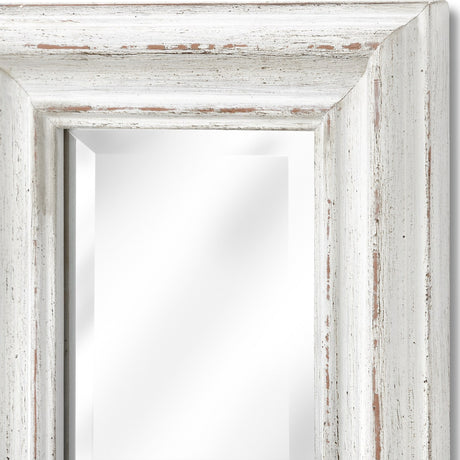 Close-up of the Hill Interiors Narrow Antique White Framed Wall Mirror, showing the distressed white wooden frame corner and bevelled glass.