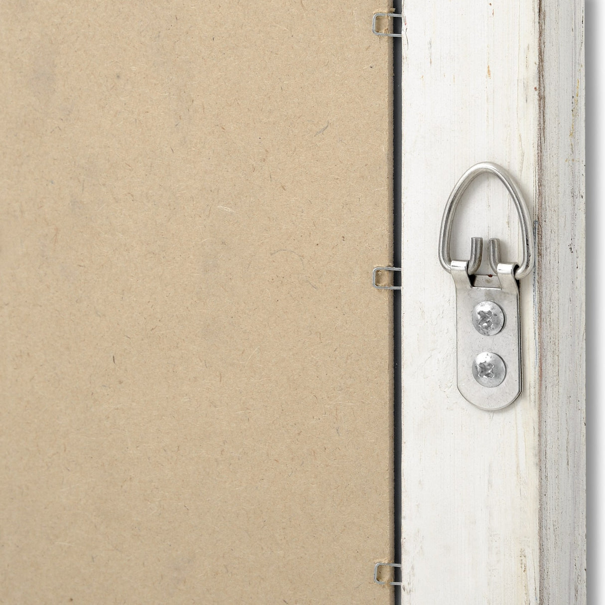 Close-up of the Hill Interiors Narrow Antique White Framed Wall Mirror's back corner, showing the distressed frame, D-ring hanger, and MDF backing.