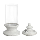 Hill Interiors Glass and Stone Pillar Candle Holder in white with a clear glass hurricane and matte stone base shown with finial lid detached.