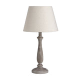 Hill Interiors Wooden Table Lamp in beige with a turned wood base and tapered linen shade, shown on a plain white background.