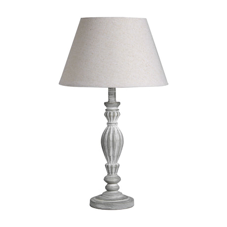 Hill Interiors Wooden Table Lamp in beige with a turned, fluted solid wood base and tapered cream linen shade, shown on a plain white background.