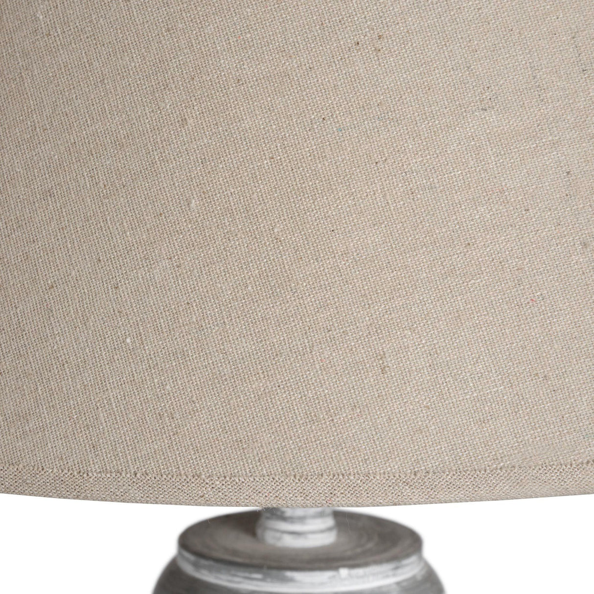 Close-up of the beige fabric drum shade and turned wooden base on the Hill Interiors Wooden Floor Lamp, showing woven texture and soft wood grain.