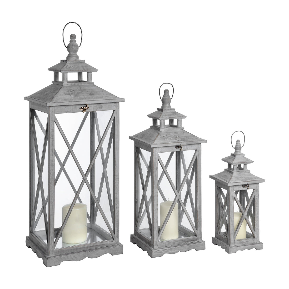 Hill Interiors set of three wooden lanterns in graduated heights, grey finish with cross-section glazed panels and pillar candles, on a white background.